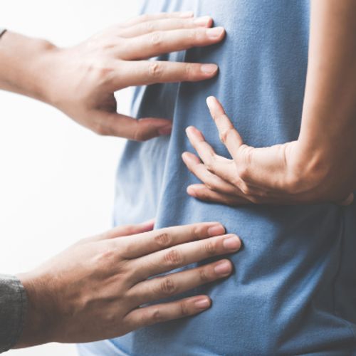 Doctor Inspecting Patient's Back Pain