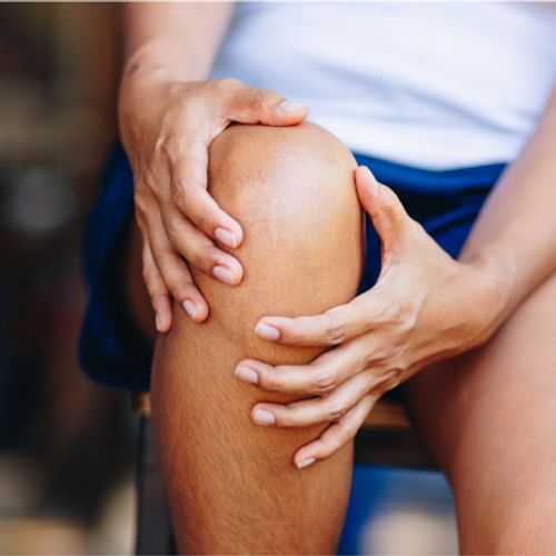Man holding knee in pain